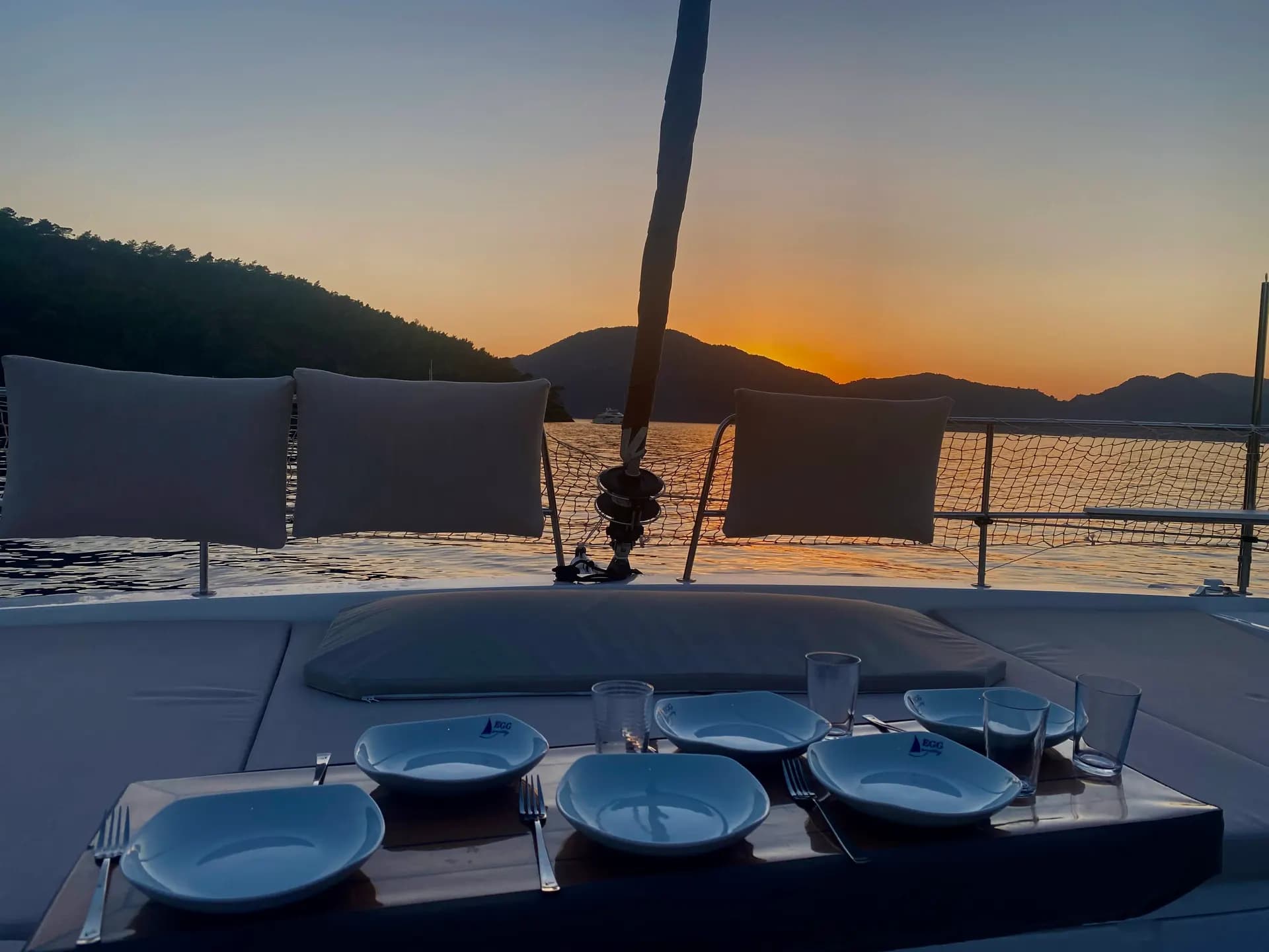 Dinner table set in the cockpit at sunset
