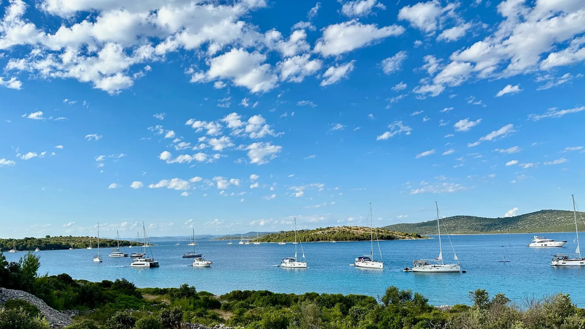 Wide bay with sailboats at anchor