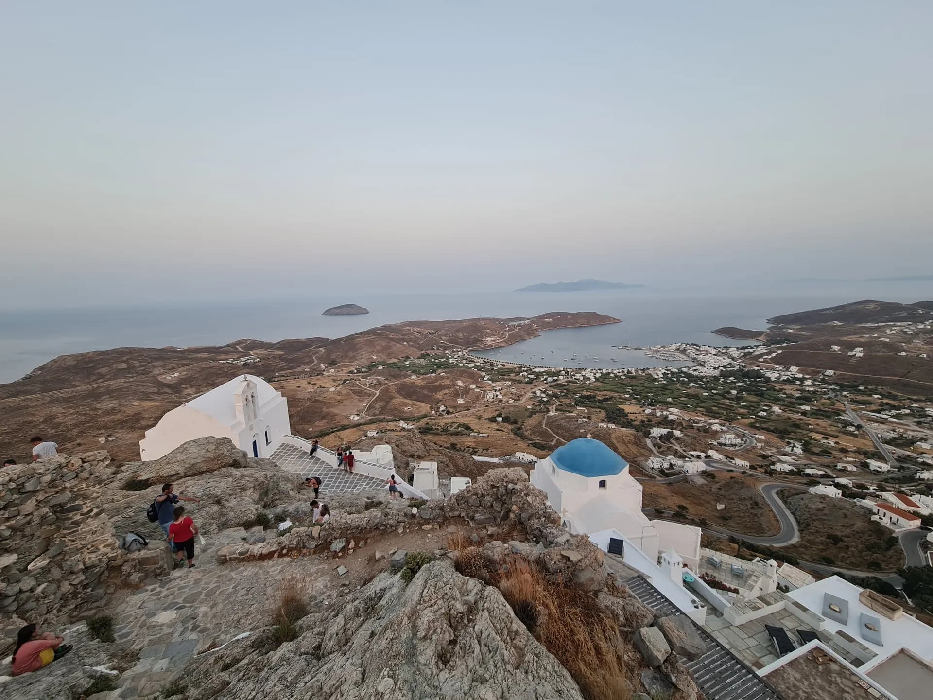 View from a hilltop village over a Greek island bay